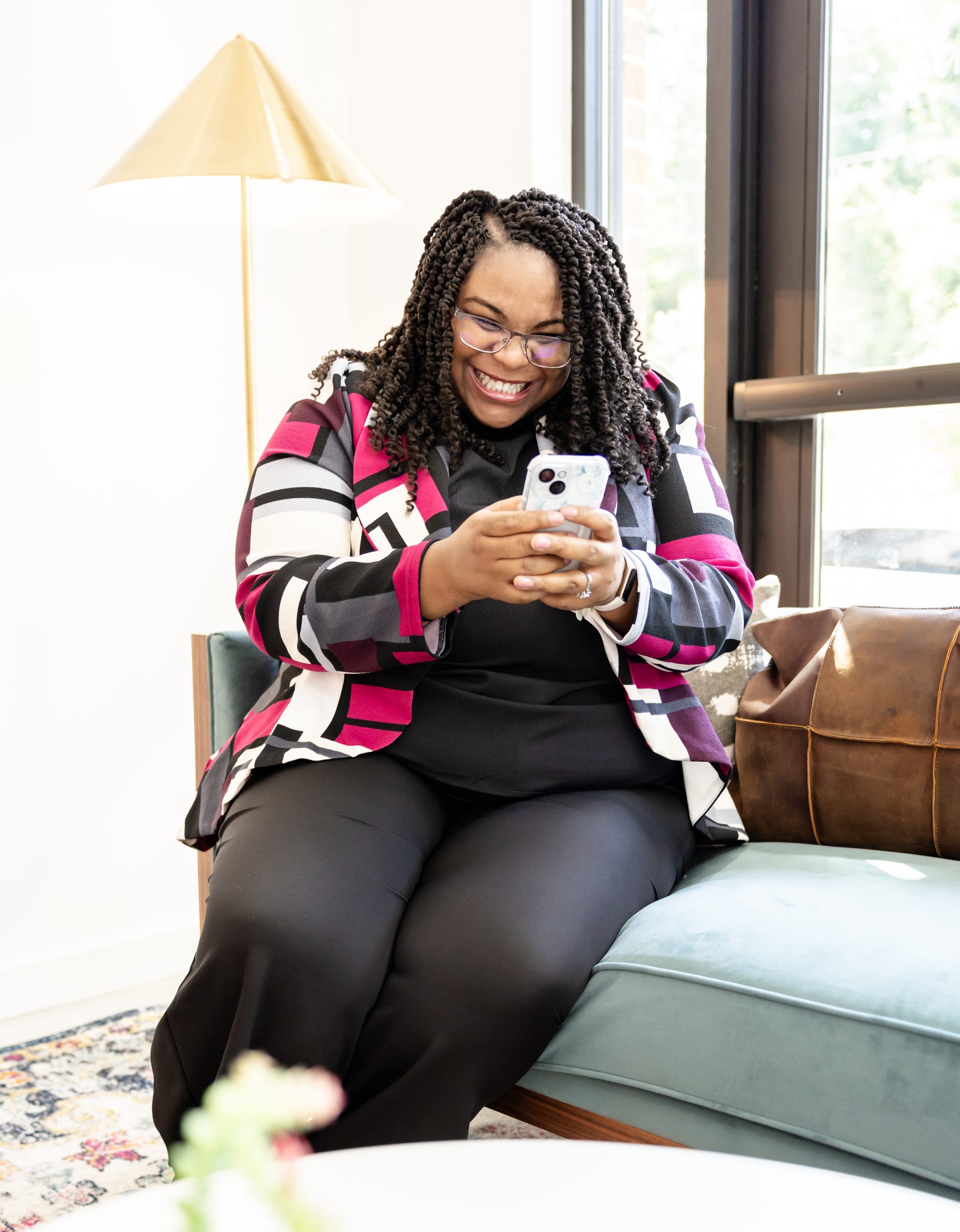 Anitra Deen looking at her phone smiling